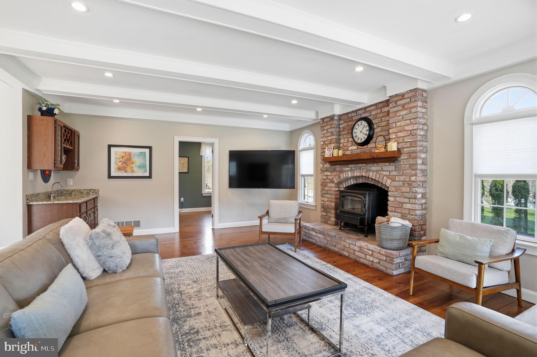 2840 West Fox Chase Circle Doylestown, PA 18902 - Photo 12 of 47 a living room with furniture a flat screen tv and a fireplace