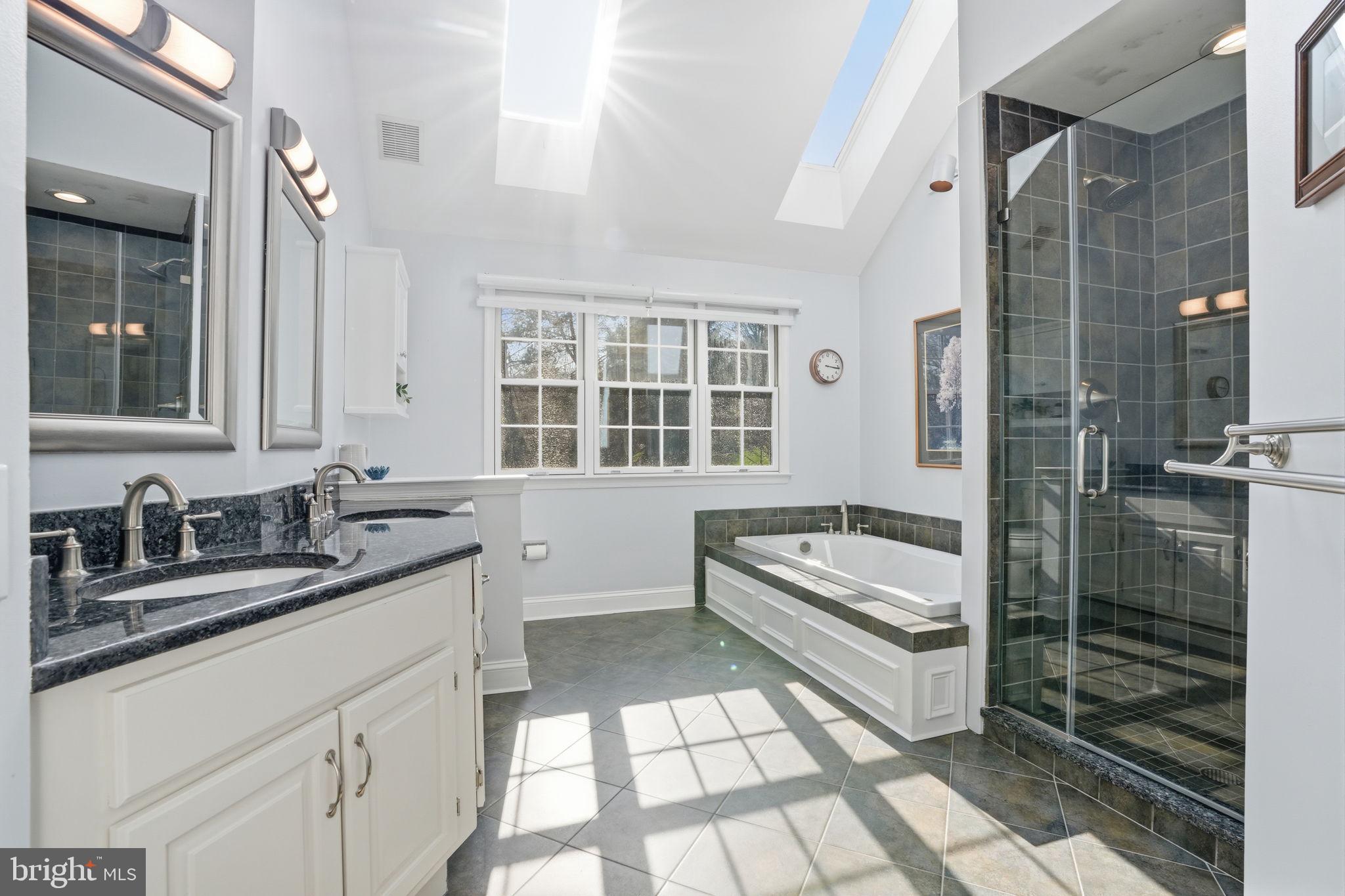 2840 West Fox Chase Circle Doylestown, PA 18902 - Photo 23 of 47 a bathroom with a granite countertop sink a mirror and a bathtub