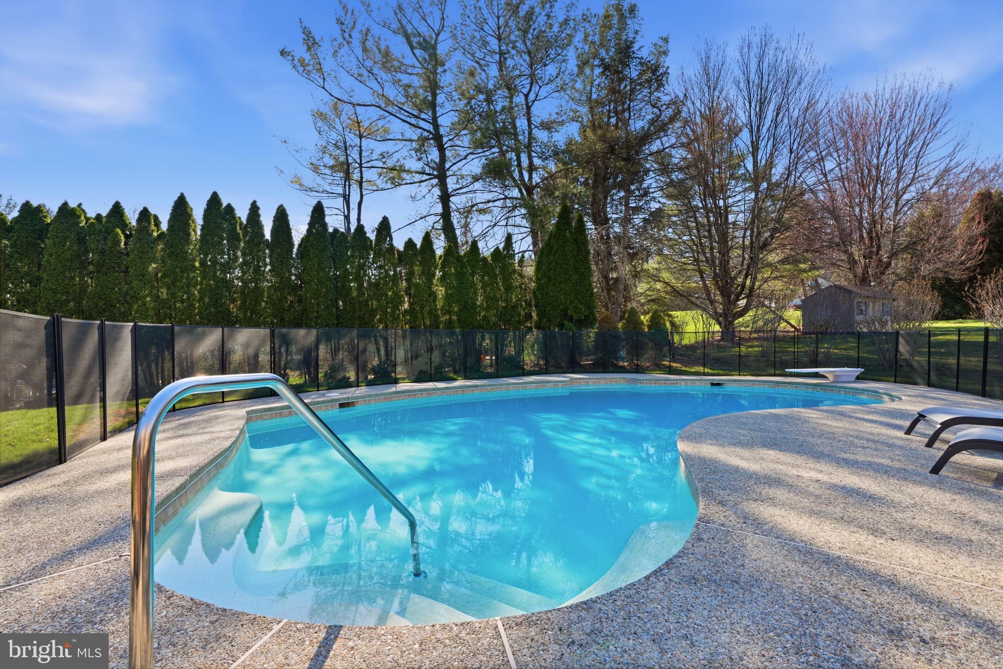 2840 West Fox Chase Circle Doylestown, PA 18902 - Photo 38 of 47 a view of a swimming pool with a yard and trees in the background
