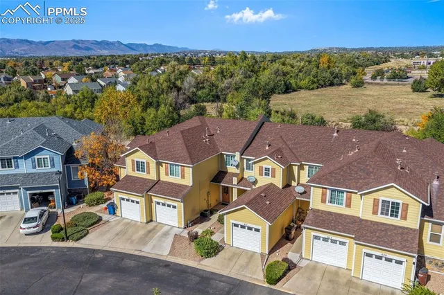 an aerial view of residential houses with outdoor space and street view