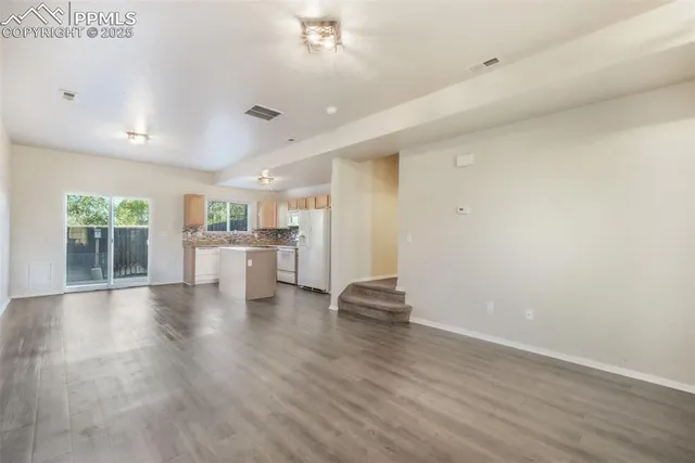 a view of a kitchen with a sink and a stove top oven
