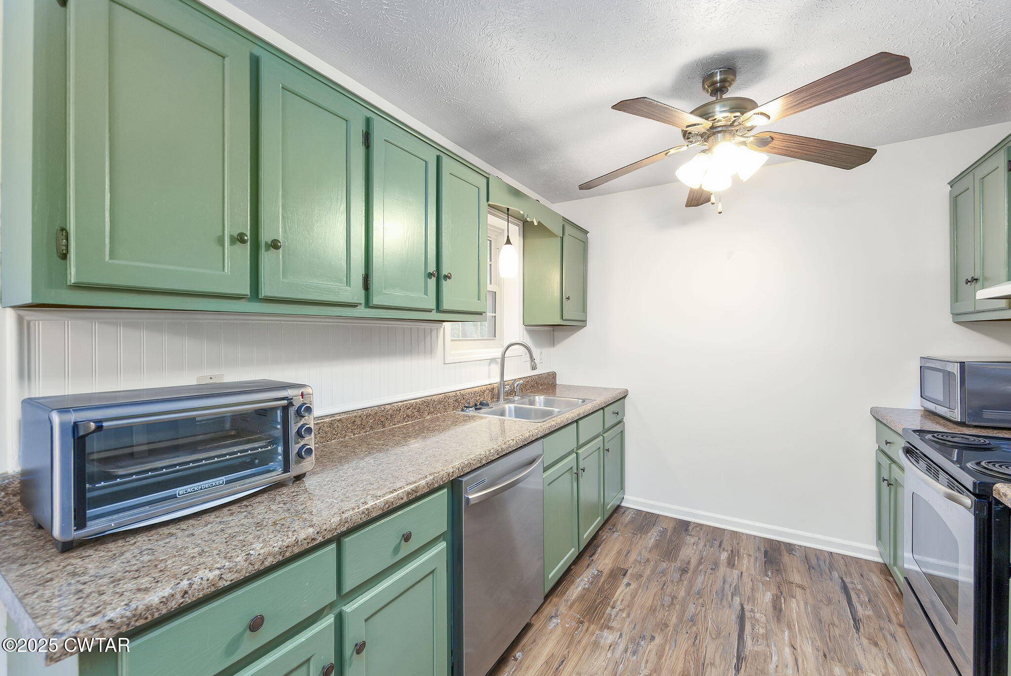 46 Commanche Cove Jackson, TN 38305 - Photo 17 of 26 a kitchen with granite countertop cabinets stainless steel appliances and a wooden floor