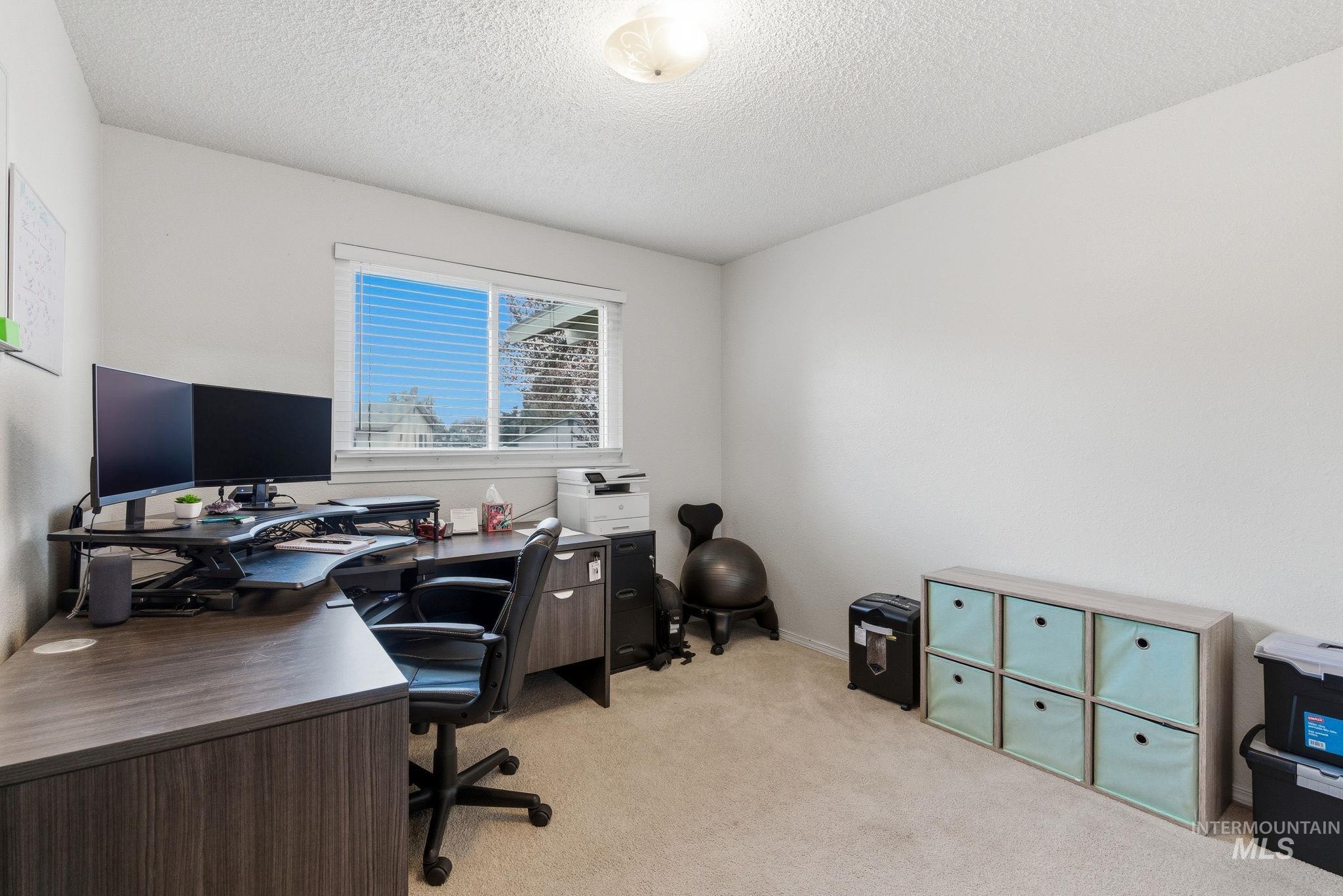 598 Easy Street Kuna, ID 83634 - Photo 20 of 50 Office area with light carpet and a textured ceiling