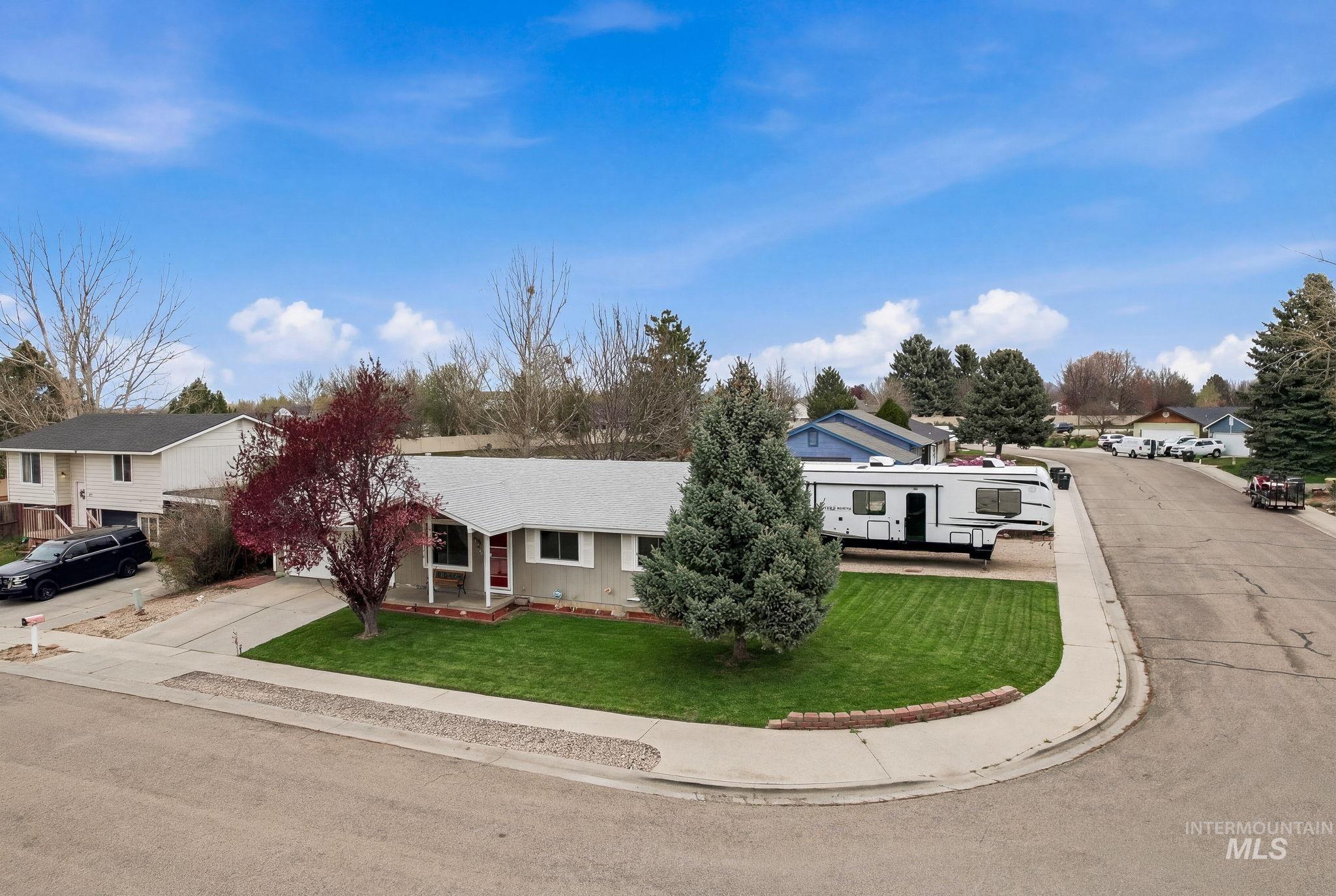 598 Easy Street Kuna, ID 83634 - Photo 2 of 50 View of front of house featuring a porch, a front lawn, and a residential view