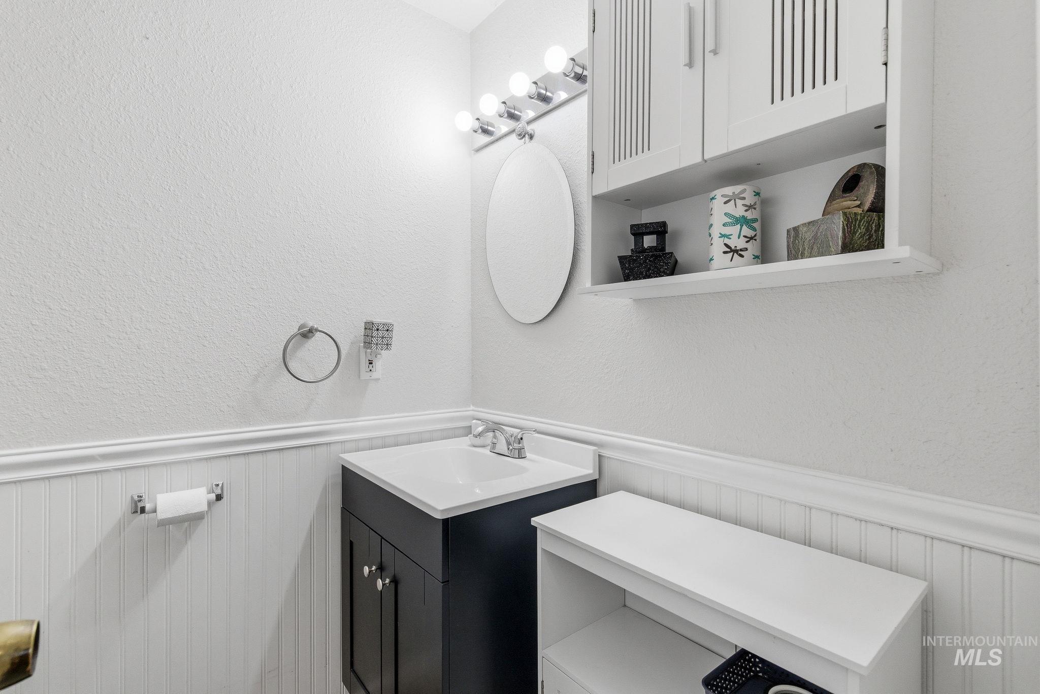598 Easy Street Kuna, ID 83634 - Photo 31 of 50 Bathroom featuring wainscoting, vanity, and a textured wall