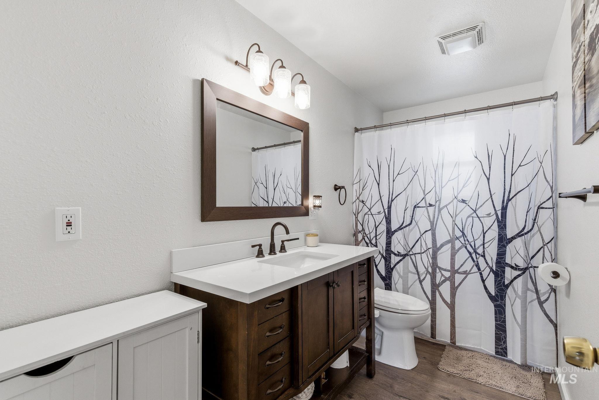 598 Easy Street Kuna, ID 83634 - Photo 32 of 50 Full bathroom featuring vanity, a shower with curtain, and dark wood-type flooring