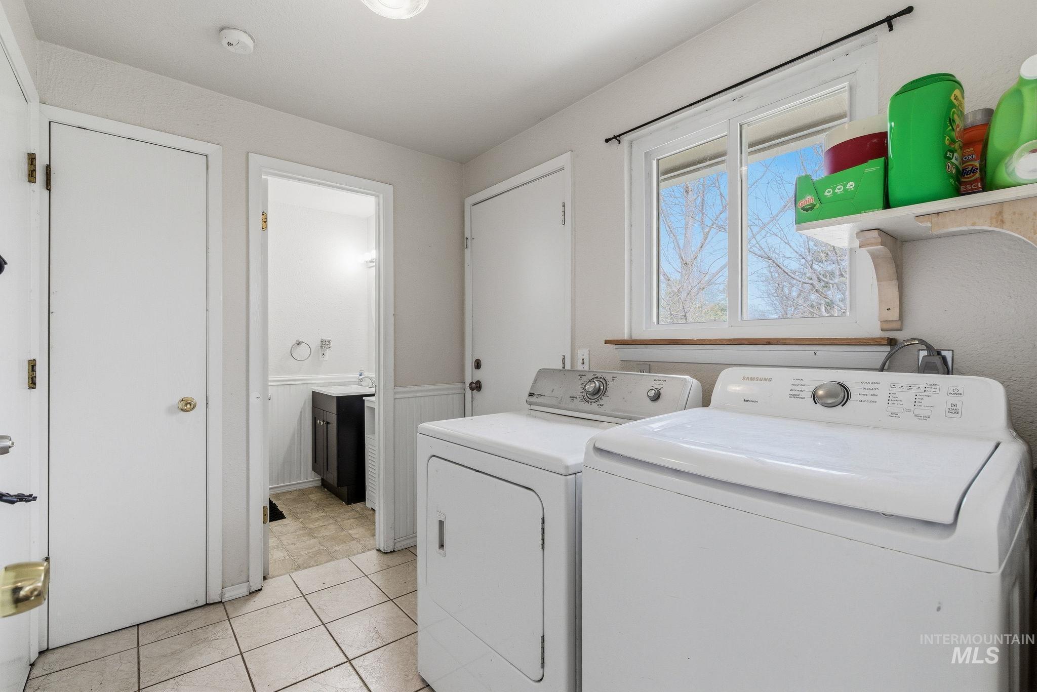 598 Easy Street Kuna, ID 83634 - Photo 33 of 50 Laundry room featuring wainscoting, independent washer and dryer, and light tile patterned flooring
