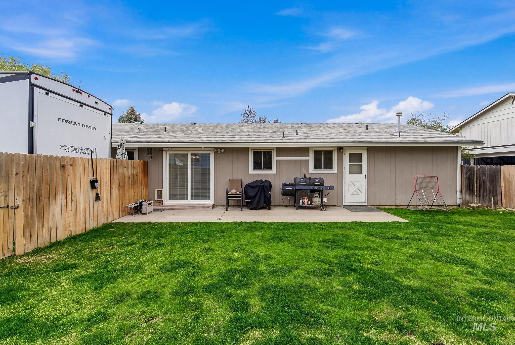 598 Easy Street Kuna, ID 83634 - Photo 36 of 50 Back of house with a fenced backyard, a patio area, and a shingled roof