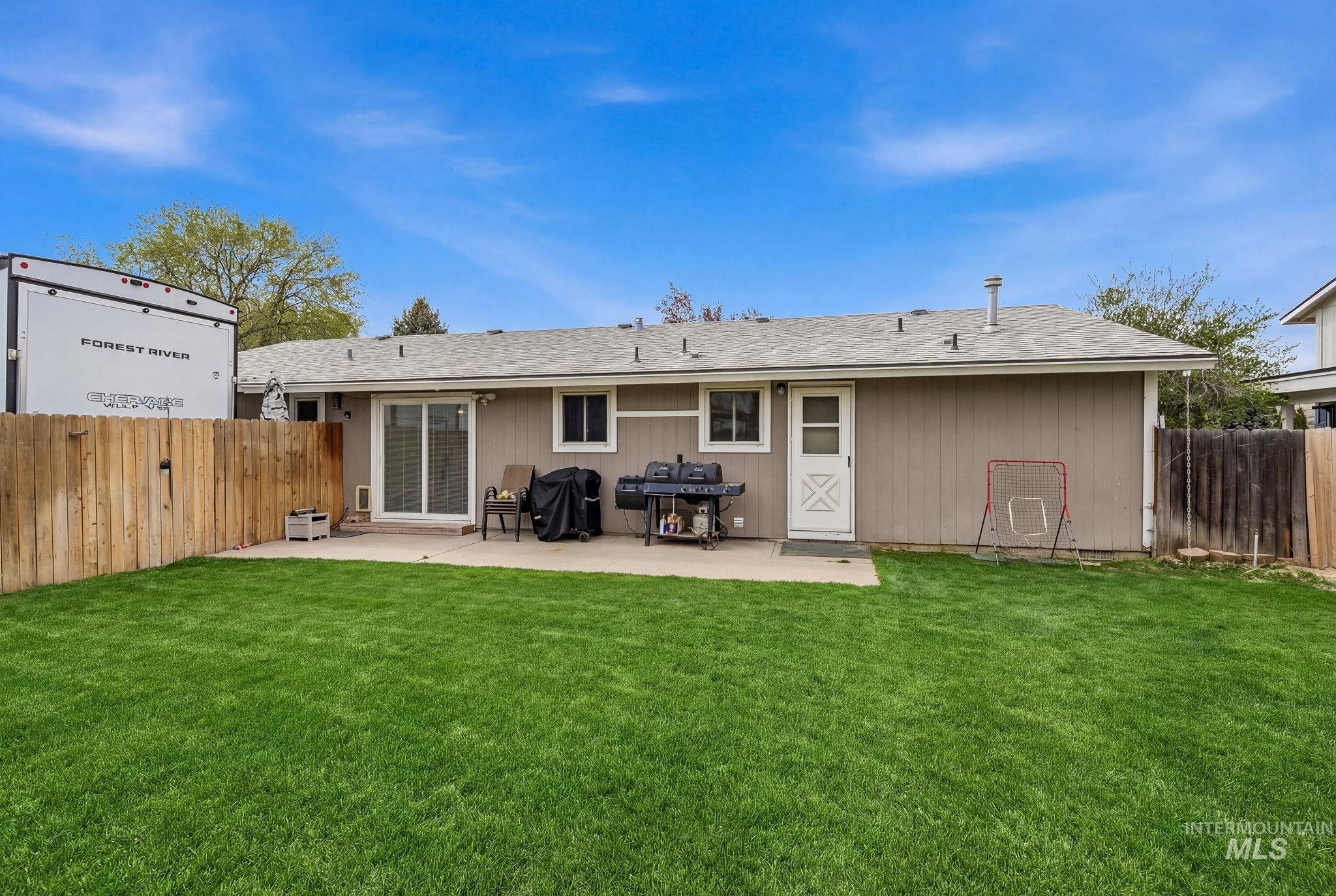 598 Easy Street Kuna, ID 83634 - Photo 37 of 50 Back of property with a fenced backyard, roof with shingles, and a patio