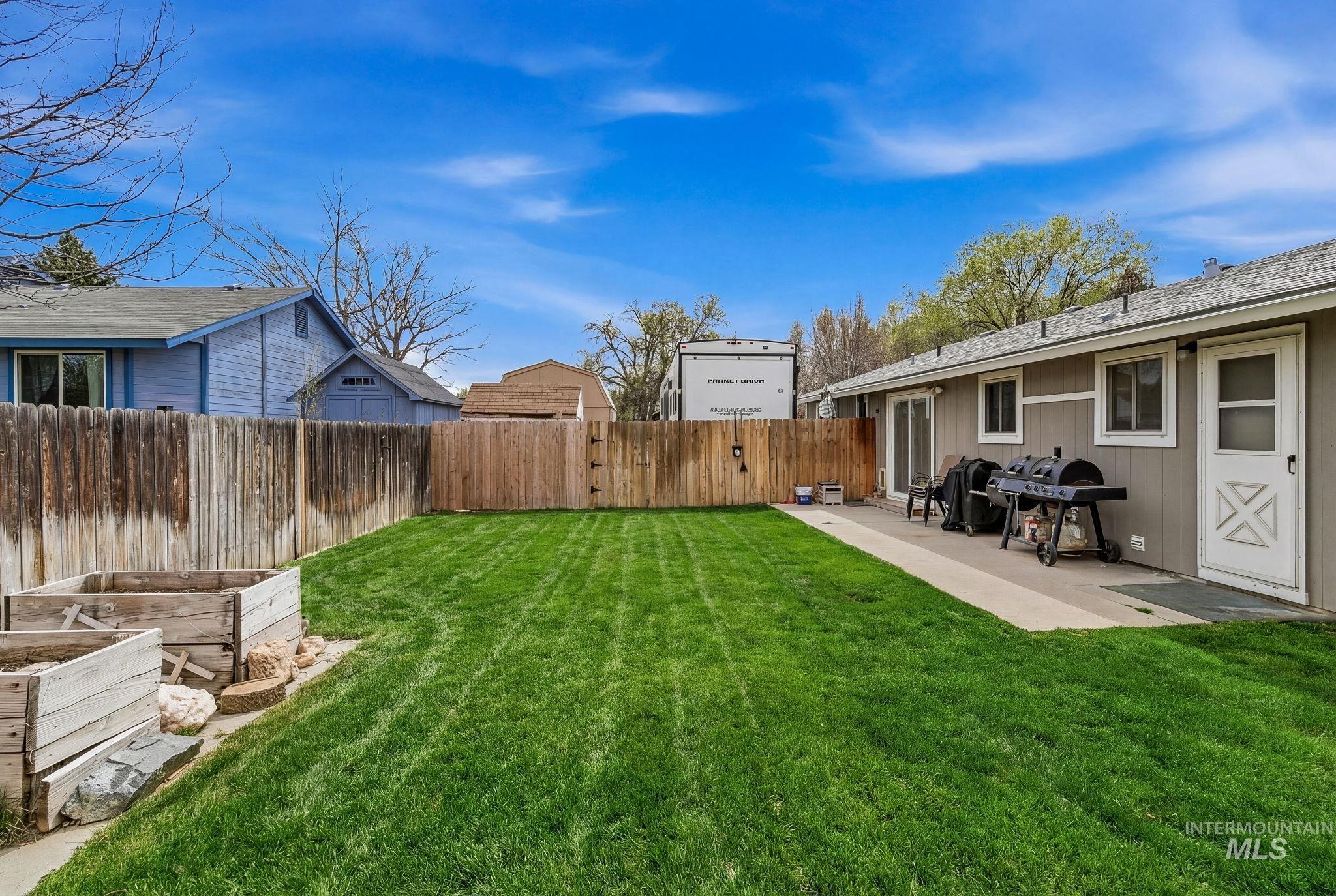 598 Easy Street Kuna, ID 83634 - Photo 38 of 50 Fenced backyard featuring a vegetable garden and a patio area