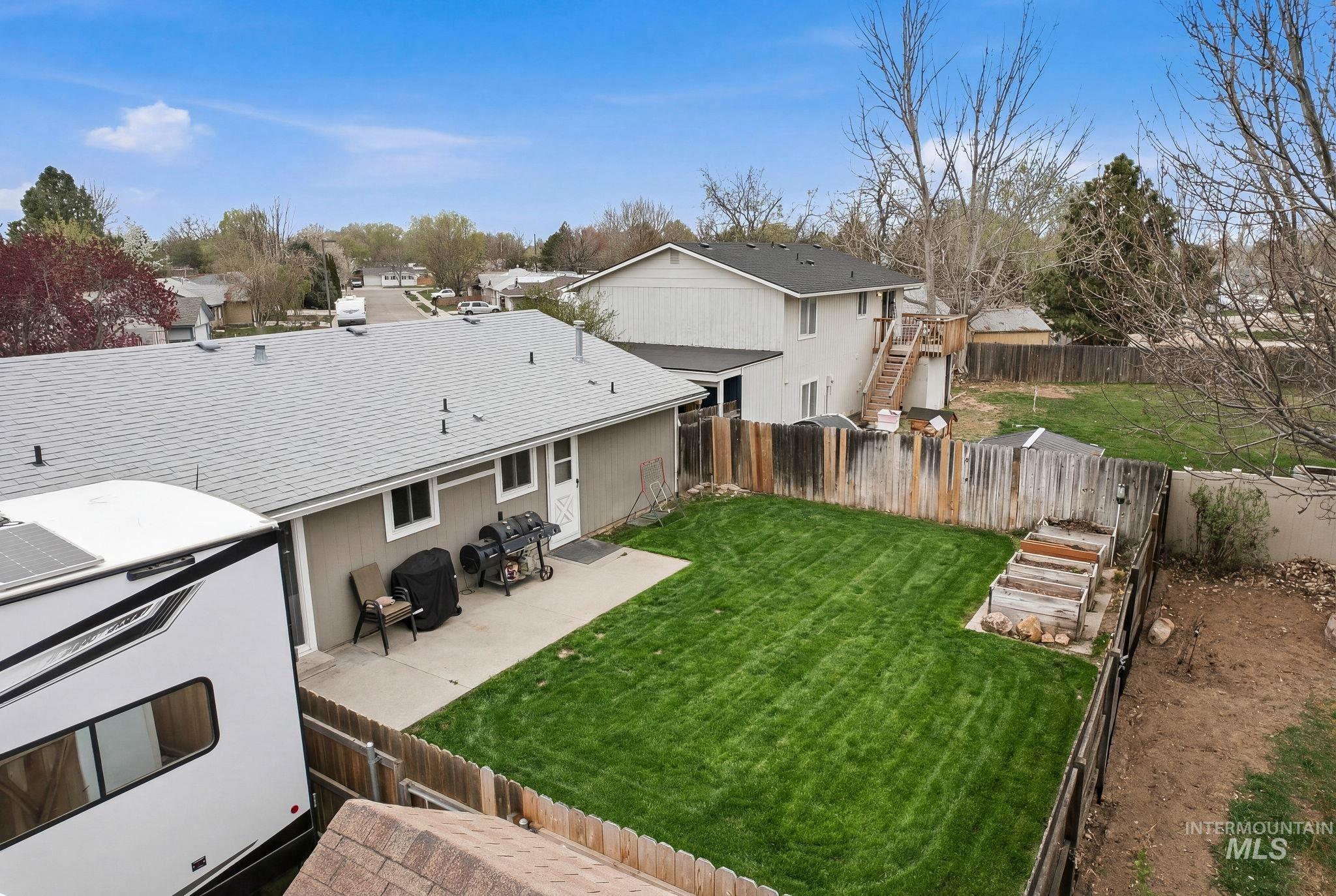 598 Easy Street Kuna, ID 83634 - Photo 43 of 50 Rear view of property featuring a fenced backyard, a patio area, and a shingled roof