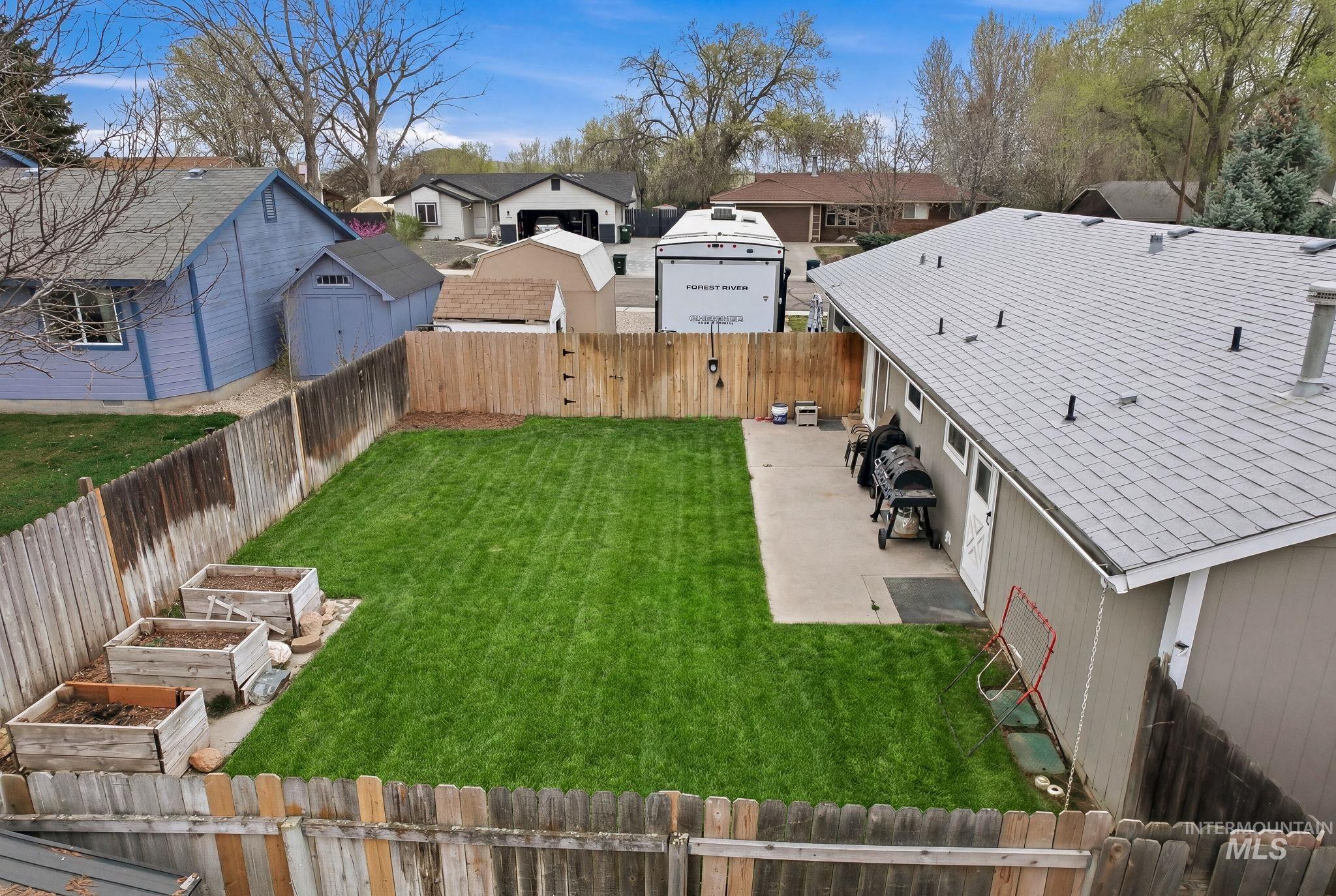 598 Easy Street Kuna, ID 83634 - Photo 44 of 50 Fenced backyard featuring a residential view, a gate, and a garden