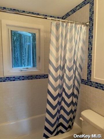 790 Surf Road Ocean Beach, NY 11770 - Photo 5 of 8 a bathroom with a shower curtain and a sink