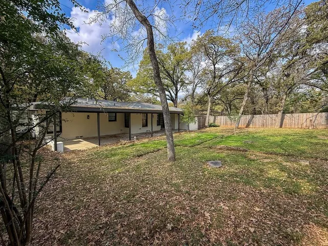 a view of a house with yard and a tree
