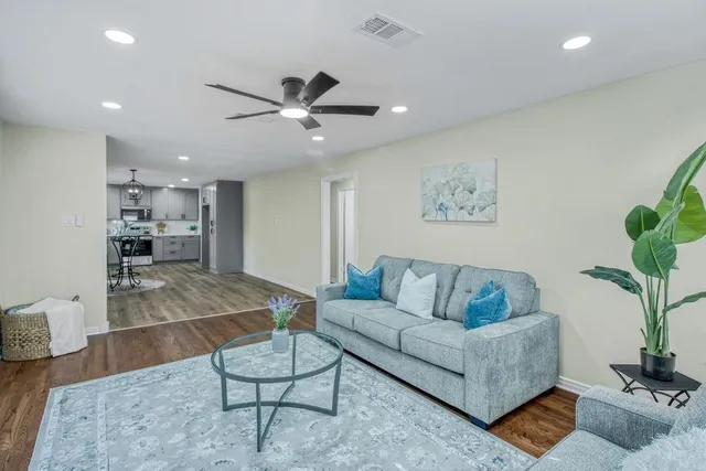 a living room with furniture and a potted plant
