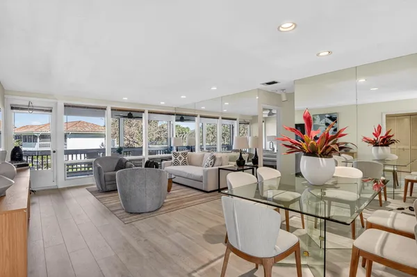 a living room with fireplace furniture and a potted plant