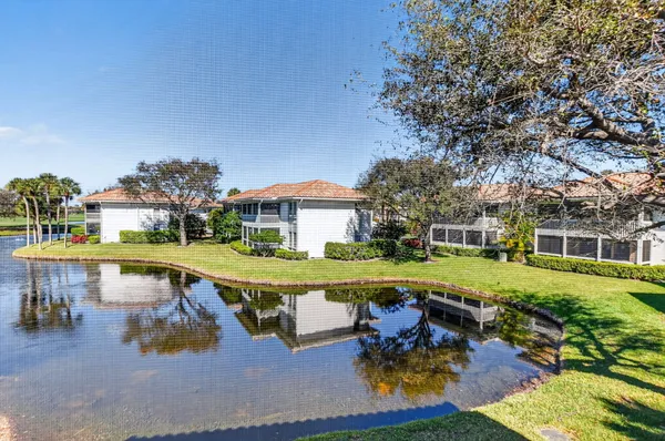 a view of a swimming pool with a patio and a yard