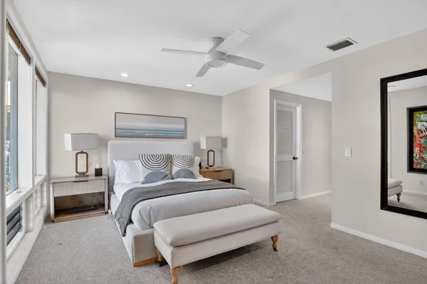 a dining room with wooden floor fan and a floor to ceiling window