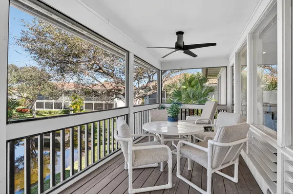a living room with furniture and large windows
