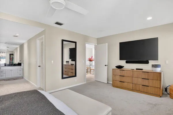 a kitchen with a sink stainless steel appliances and white cabinets