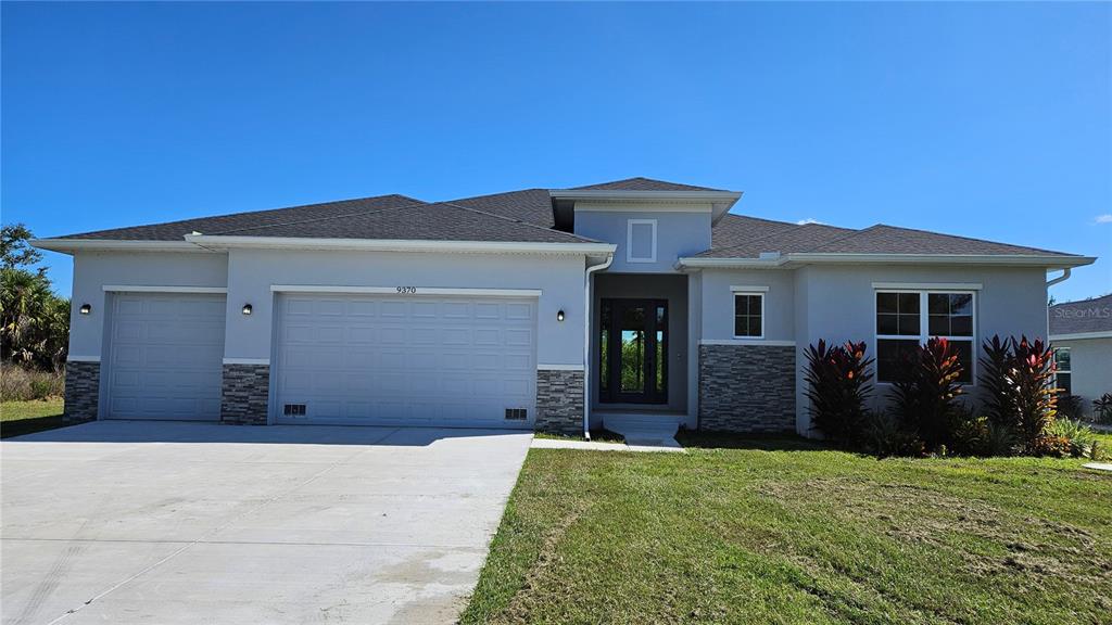 a front view of house with a garden