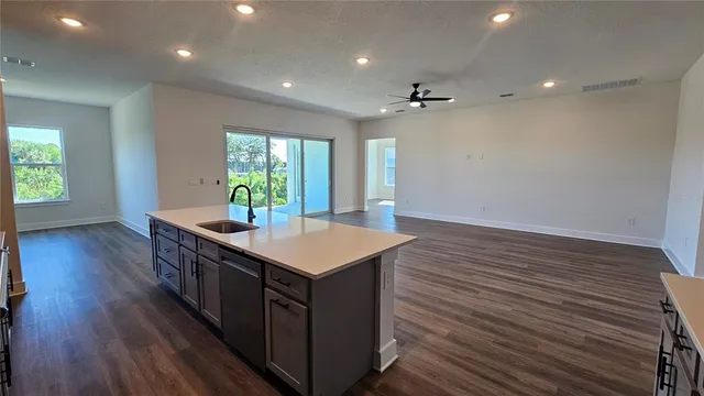 an open kitchen with a sink and dish washer