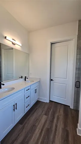 a bathroom with a double vanity sink and mirror