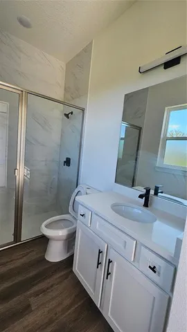 a bathroom with a sink toilet and shower