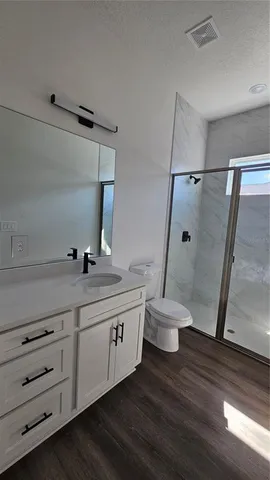 a bathroom with a double vanity sink and a toilet