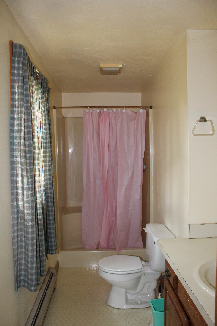 5 Pamela Way Edgartown, MA 02539 - Photo 9 of 12 a bathroom with a sink a toilet a mirror and shower curtain