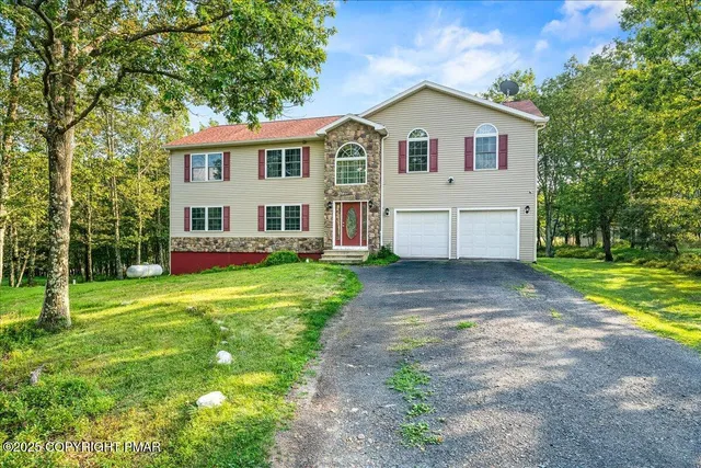 a view of a house with a yard and sitting area