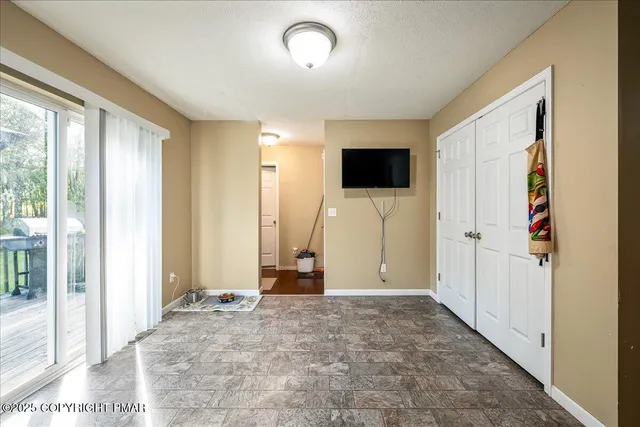 a view of a livingroom with wooden floor and a flat screen tv