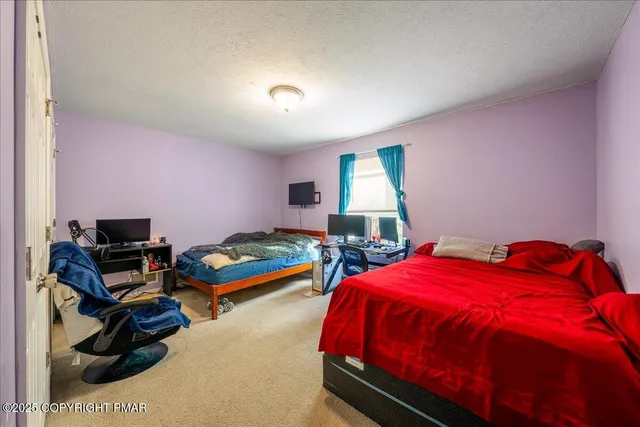 a bedroom with a bed and a car