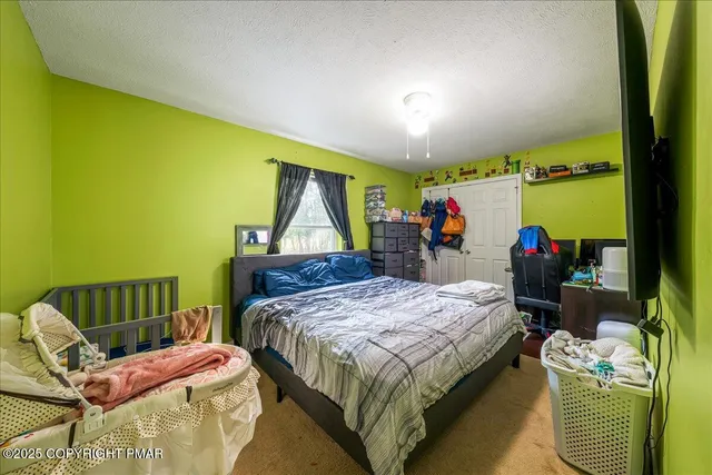 a bed room with a bed and a chair