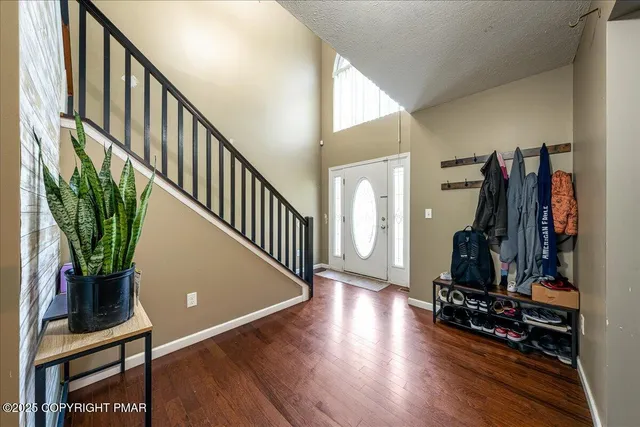 a view of a livingroom with wooden floor and stairs