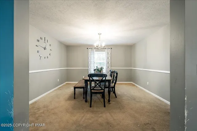 a view of a dining room with furniture and window