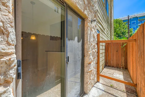 a view of a door and wooden floor in front of a building