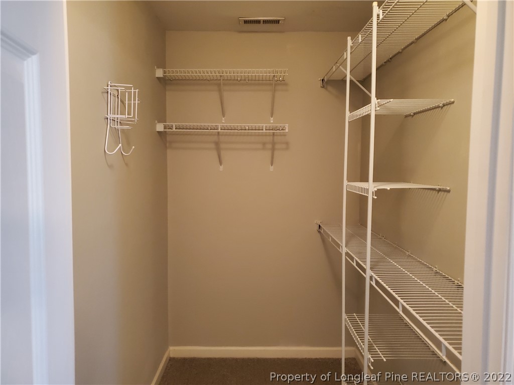 11 Sawtooth Oak Circle Bunnlevel, NC 28323 - Photo 13 of 16 a view of walk in closet with empty racks