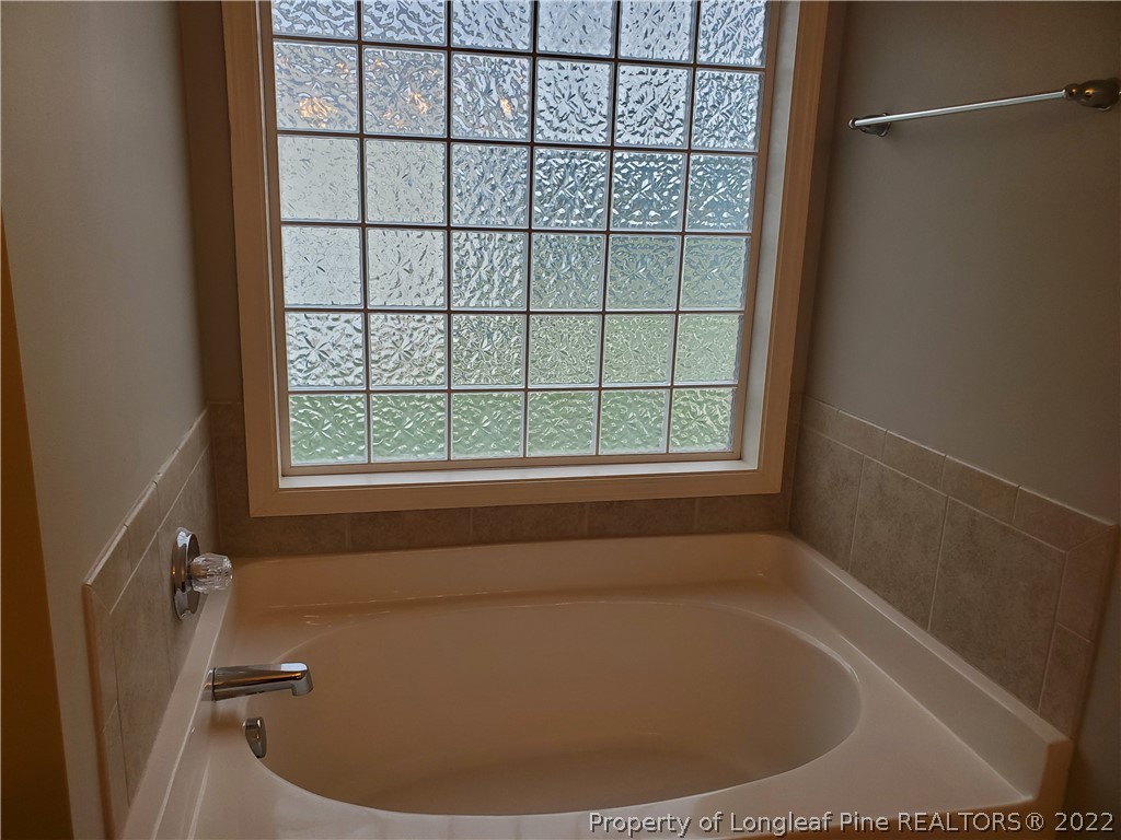 11 Sawtooth Oak Circle Bunnlevel, NC 28323 - Photo 10 of 16 a bath tub sitting in a bathroom next to a window