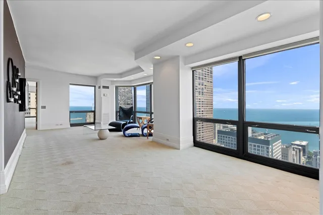 a living room with furniture and a floor to ceiling window