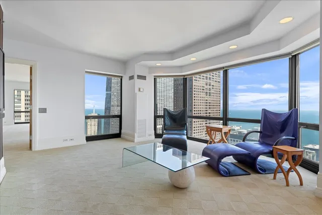 a living room with furniture and large windows