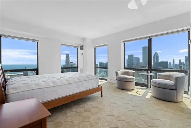 a spacious bathroom with a shower a mirror and a sink
