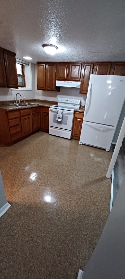 2114 Enoch Avenue, Unit 1 Zion, IL 60099 - Photo 3 of 10 a kitchen with stainless steel appliances a stove a sink and cabinets
