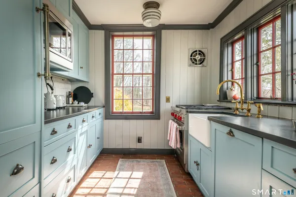 a kitchen with granite countertop a sink and a window