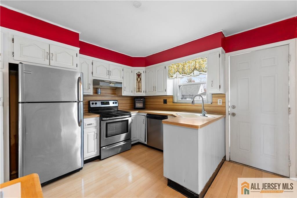 33 Prospect Lane Colonia, NJ 07067 - Photo 11 of 35 a kitchen with stainless steel appliances a refrigerator sink and stove
