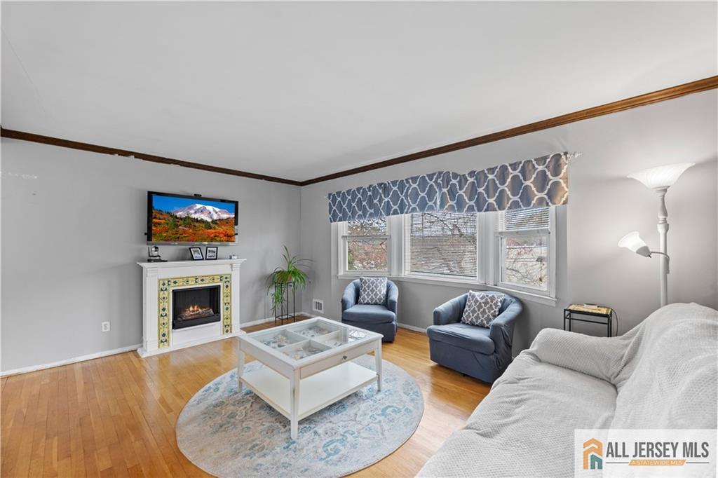 33 Prospect Lane Colonia, NJ 07067 - Photo 16 of 35 a living room with furniture and a fireplace