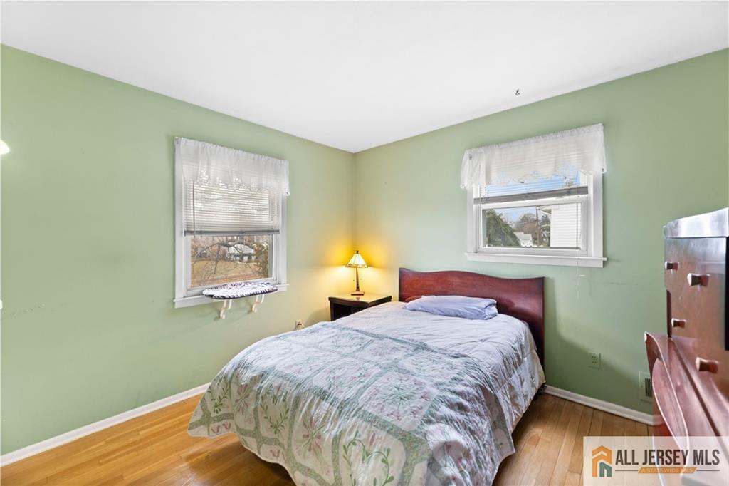 33 Prospect Lane Colonia, NJ 07067 - Photo 22 of 35 a bedroom with a bed and a painting on the wall