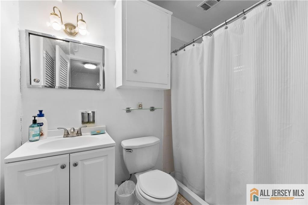 33 Prospect Lane Colonia, NJ 07067 - Photo 24 of 35 a bathroom with a sink vanity mirror and toilet