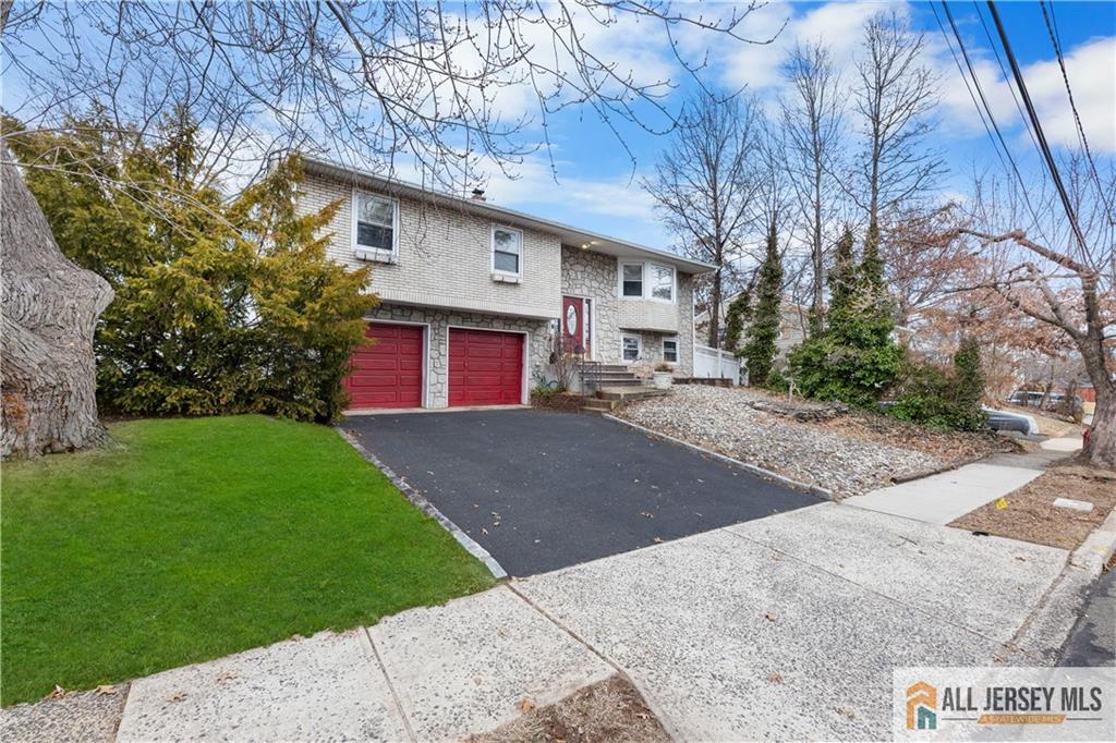 33 Prospect Lane Colonia, NJ 07067 - Photo 3 of 35 a front view of a house with a yard and garage