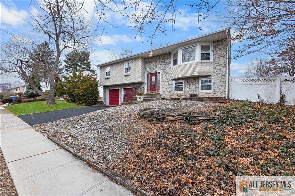 33 Prospect Lane Colonia, NJ 07067 - Photo 5 of 35 a front view of a house with a yard
